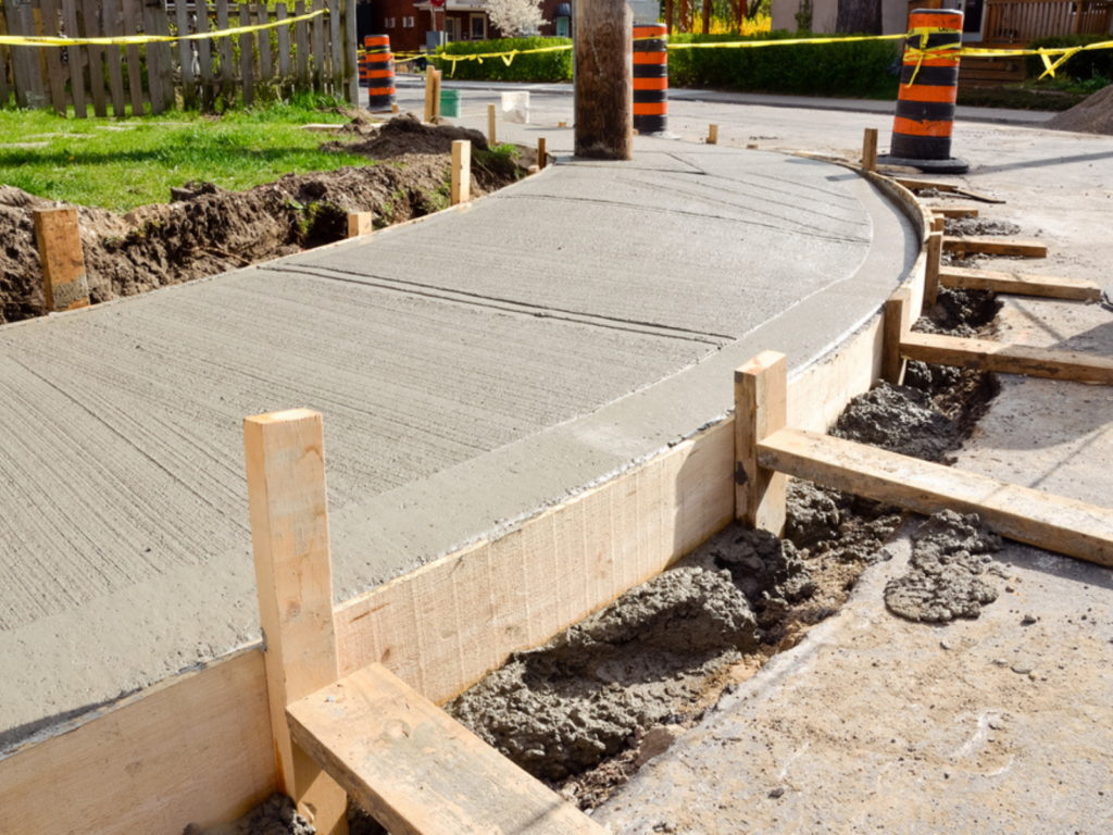 a-construction-site-with-a-curved-concrete-walkway